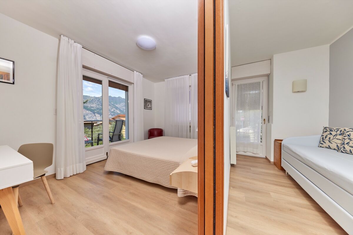 Quadruple Rooms | Camera con balcone vista giardino, adatta alle famiglie. Caratterizzate da un arredamento armonico, luminose e accoglienti.